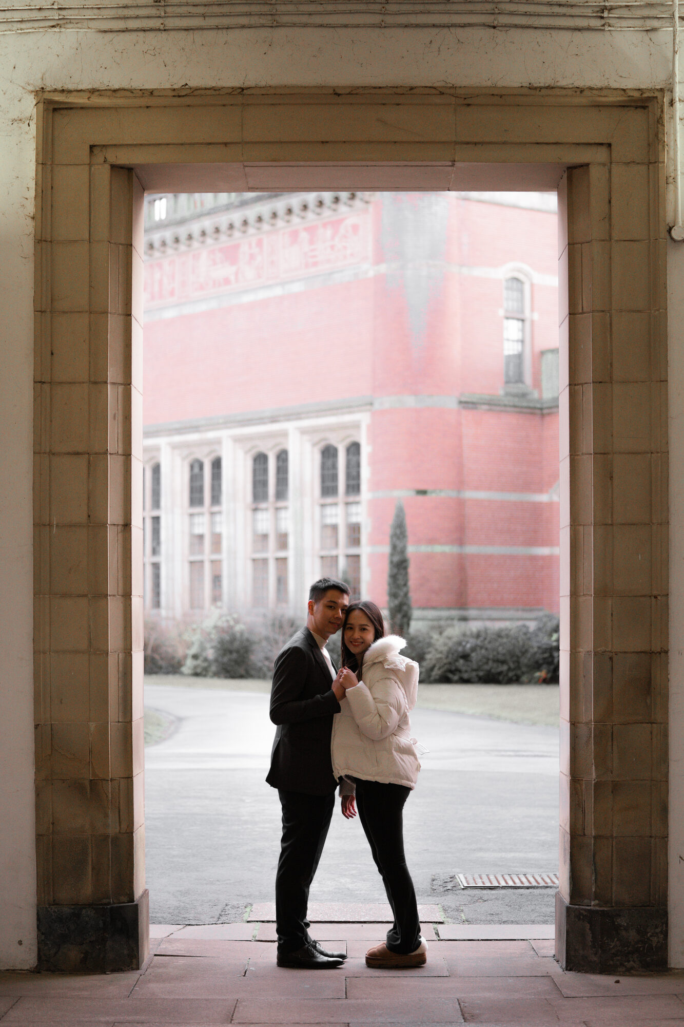 Couple embracing outside the Aston Webb building, University of Birmingham