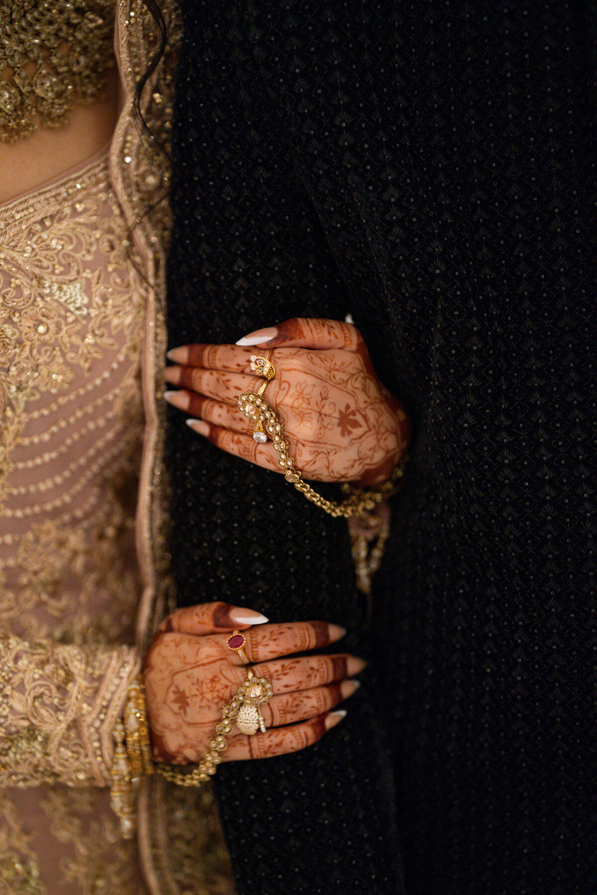 bride henna hands close up with gold jewellery